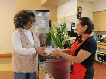 A client receiving a package from an employee.