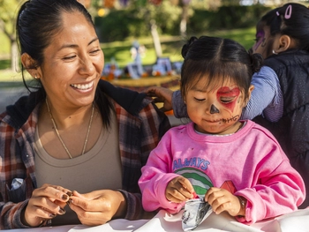 A mom and daughter working on arts and crafts.