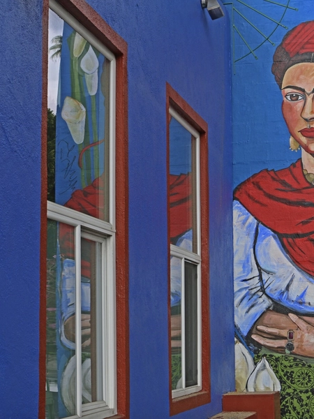 A painting of Frida Kahlo on a blue homeless shelter